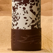 Cow print Owala bottle in sand