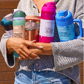 Person holding colorful Owala bottles