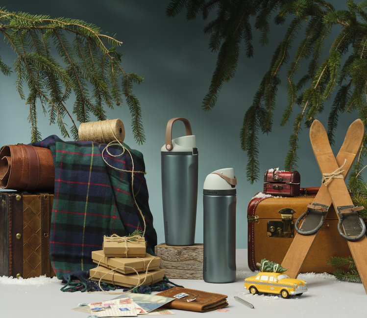 Holiday collection bottles in a cozy alpine blue lifestyle scene