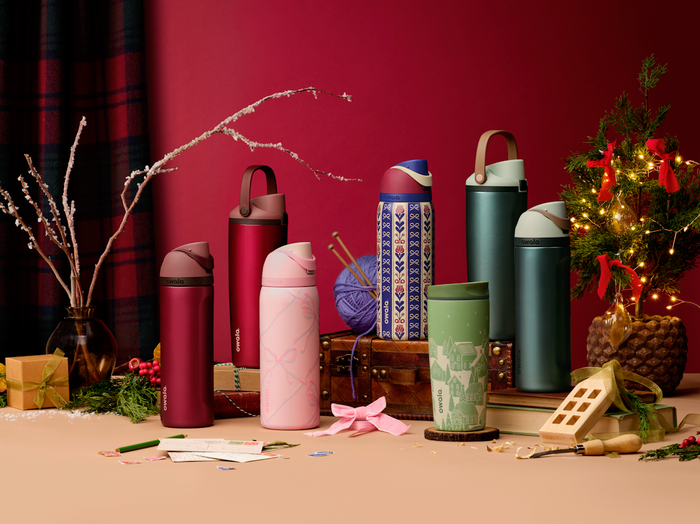Holiday collection bottles arranged with ornaments and seasonal props