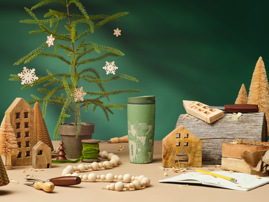 Holiday collection bottles styled with gifts, candles, and seasonal decor