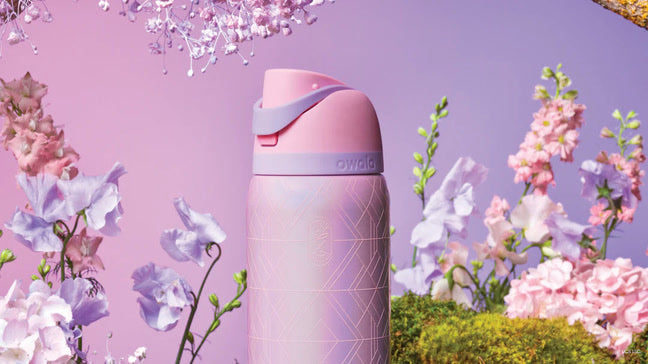 Close up shot of the pink FreeSip in front of a pink flowery backdrop