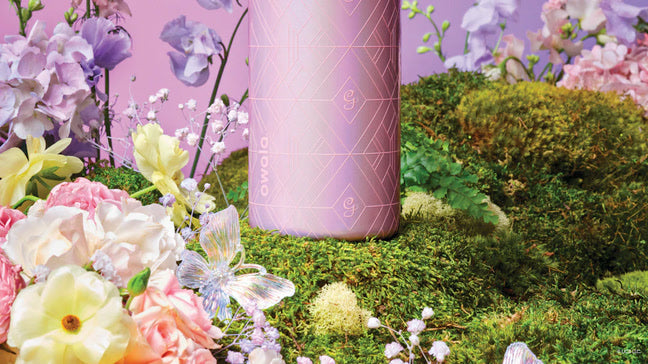 Shot of the bottom of the Glinda bottle, sitting in a grassy background