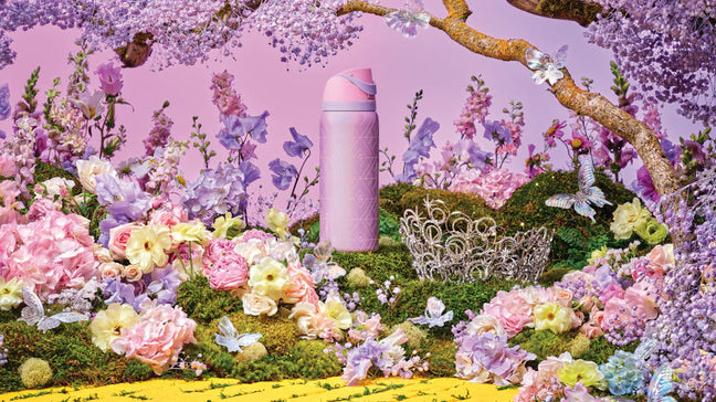 Full scene of Glinda bottle, surrounded by pastel flowers and bright scenery